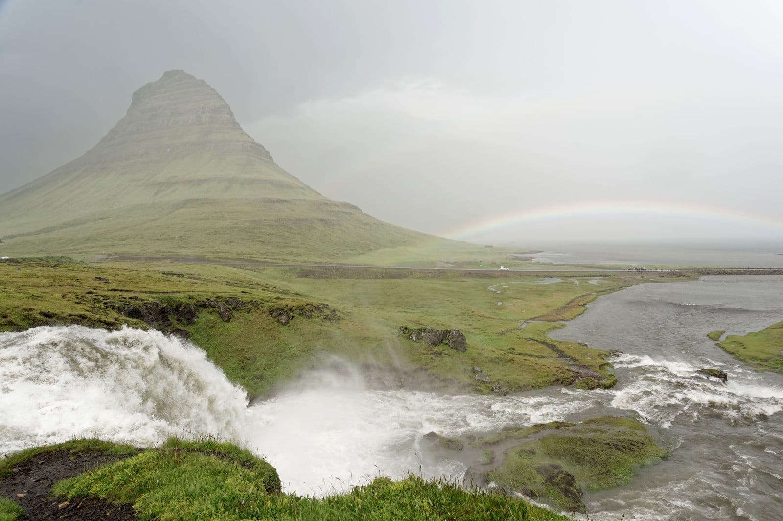 Kirkjufell Mountain, Kirkjufellsfoss waterfall and rainbow near Grundarfjörður